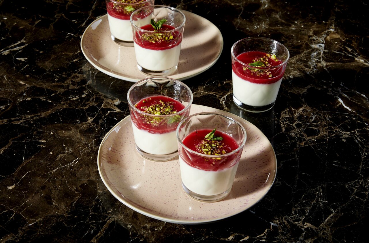 Malabi dessert in small glasses on plates